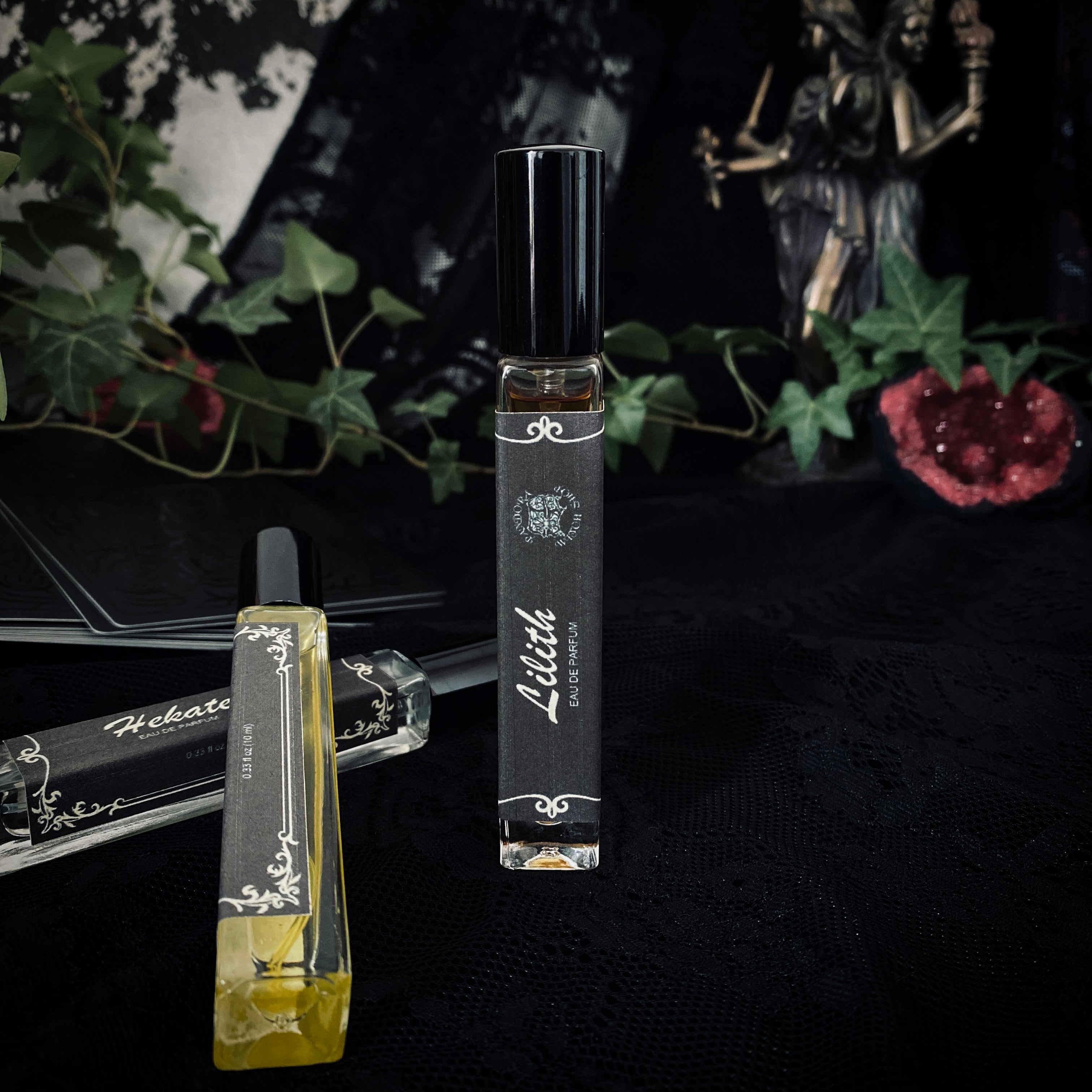 Two perfume bottles with 'Lilith' branding on a dark background with decorative elements.