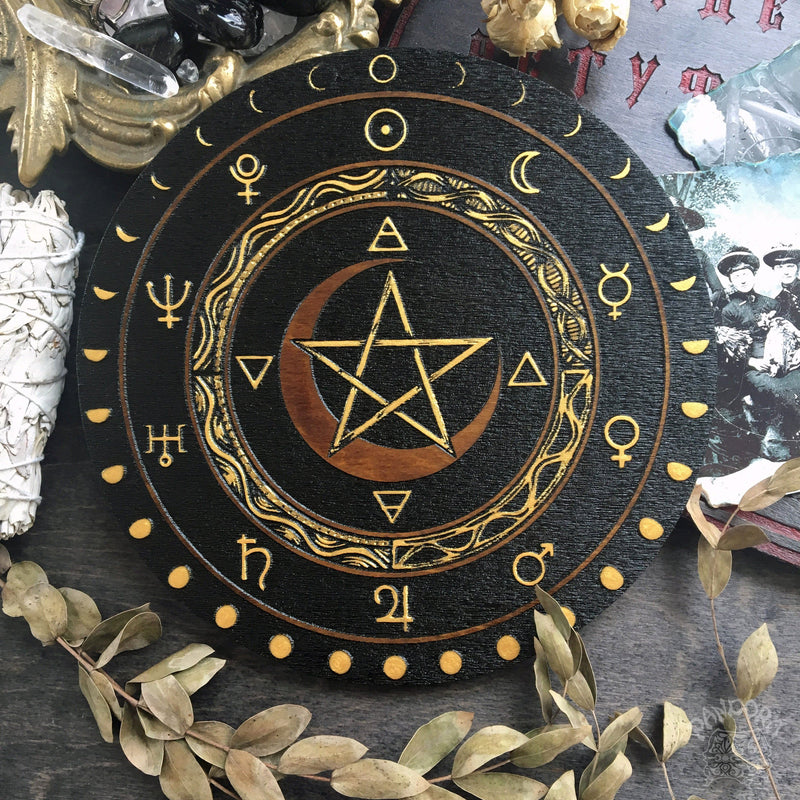 Wooden wheel with a pentagram, planet symbols and a lunar cycle