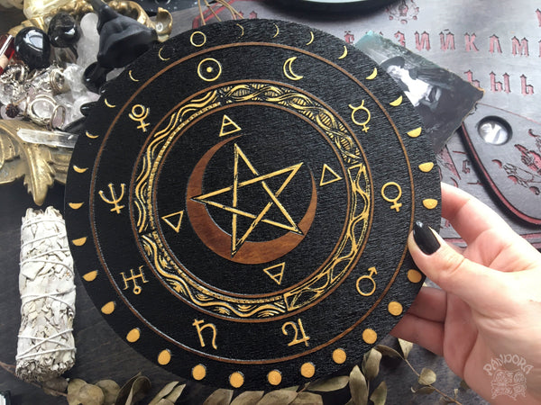 Wooden wheel with a pentagram, planet symbols and a lunar cycle