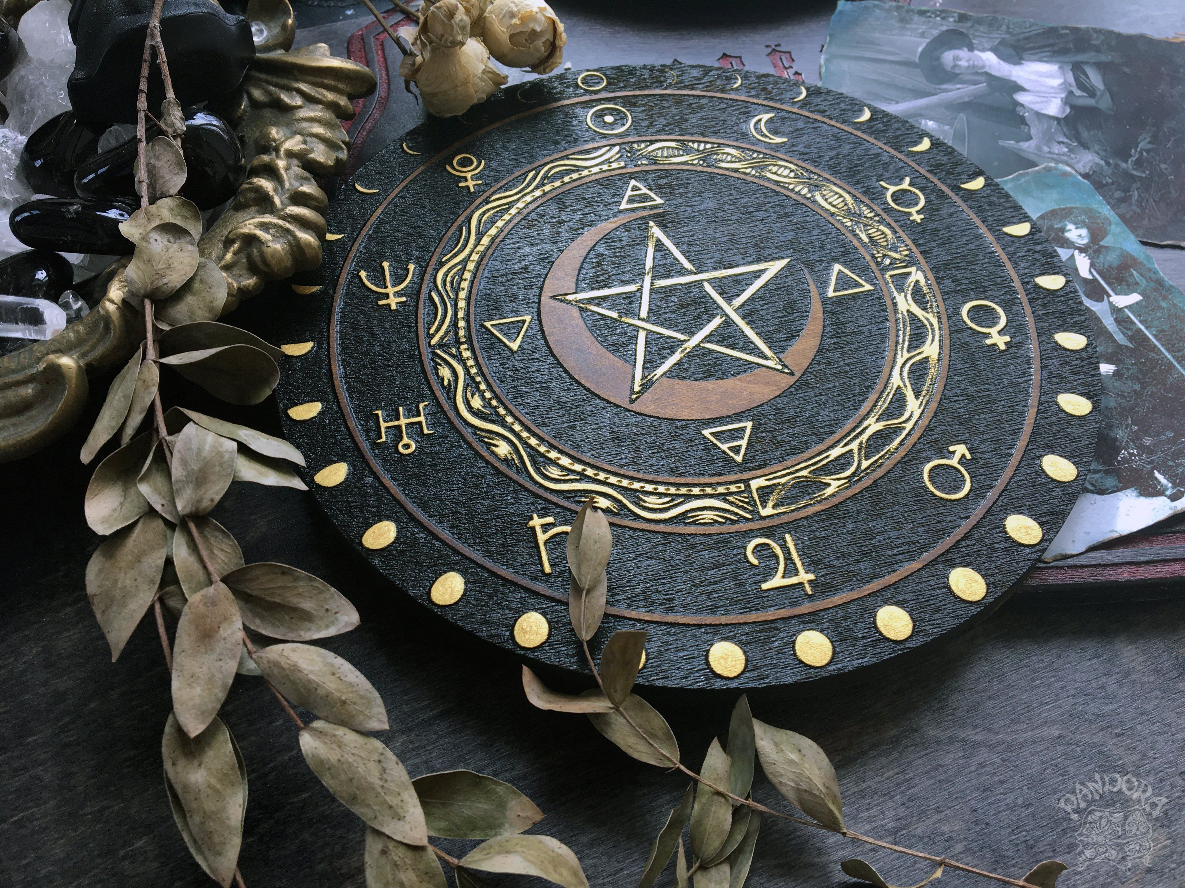 Wooden wheel with a pentagram, planet symbols and a lunar cycle