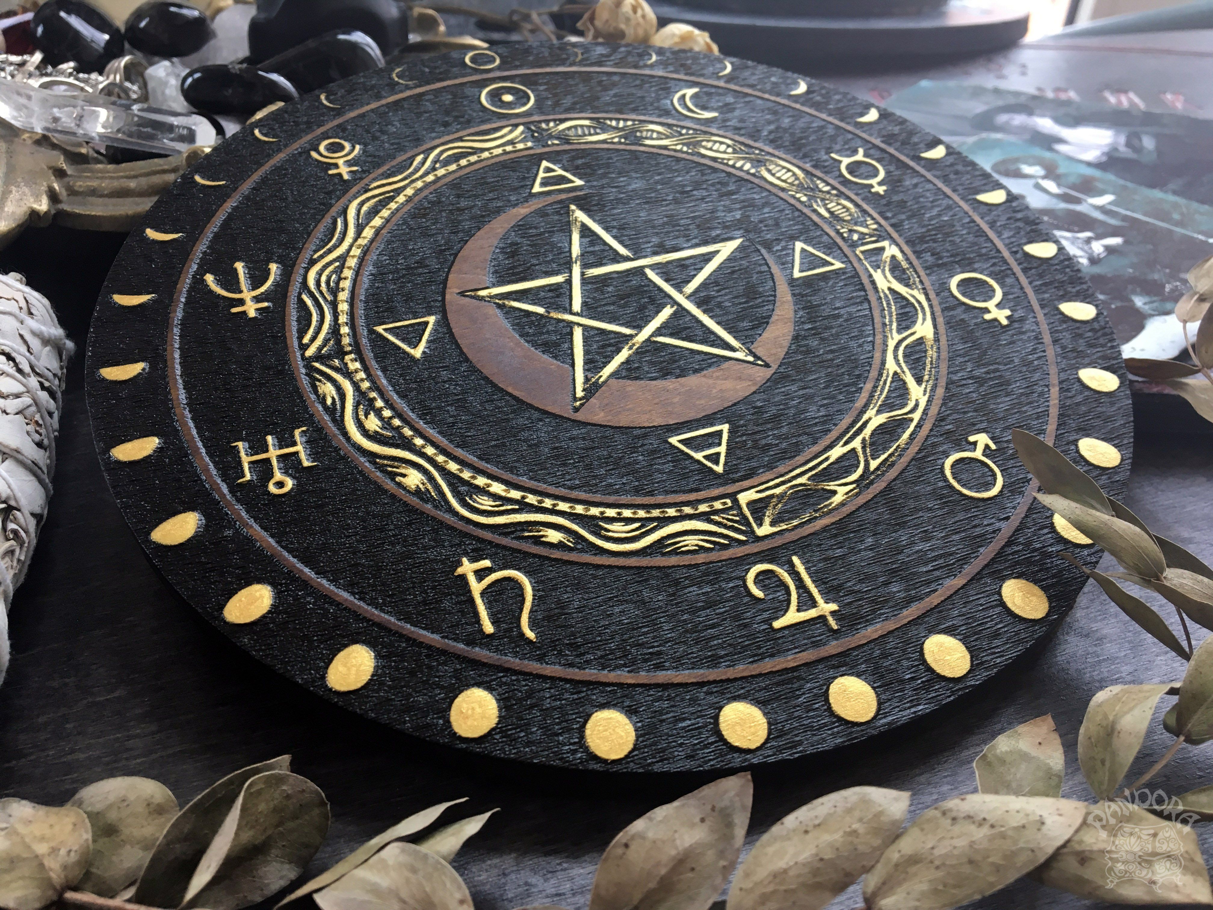 Wooden wheel with a pentagram, planet symbols and a lunar cycle