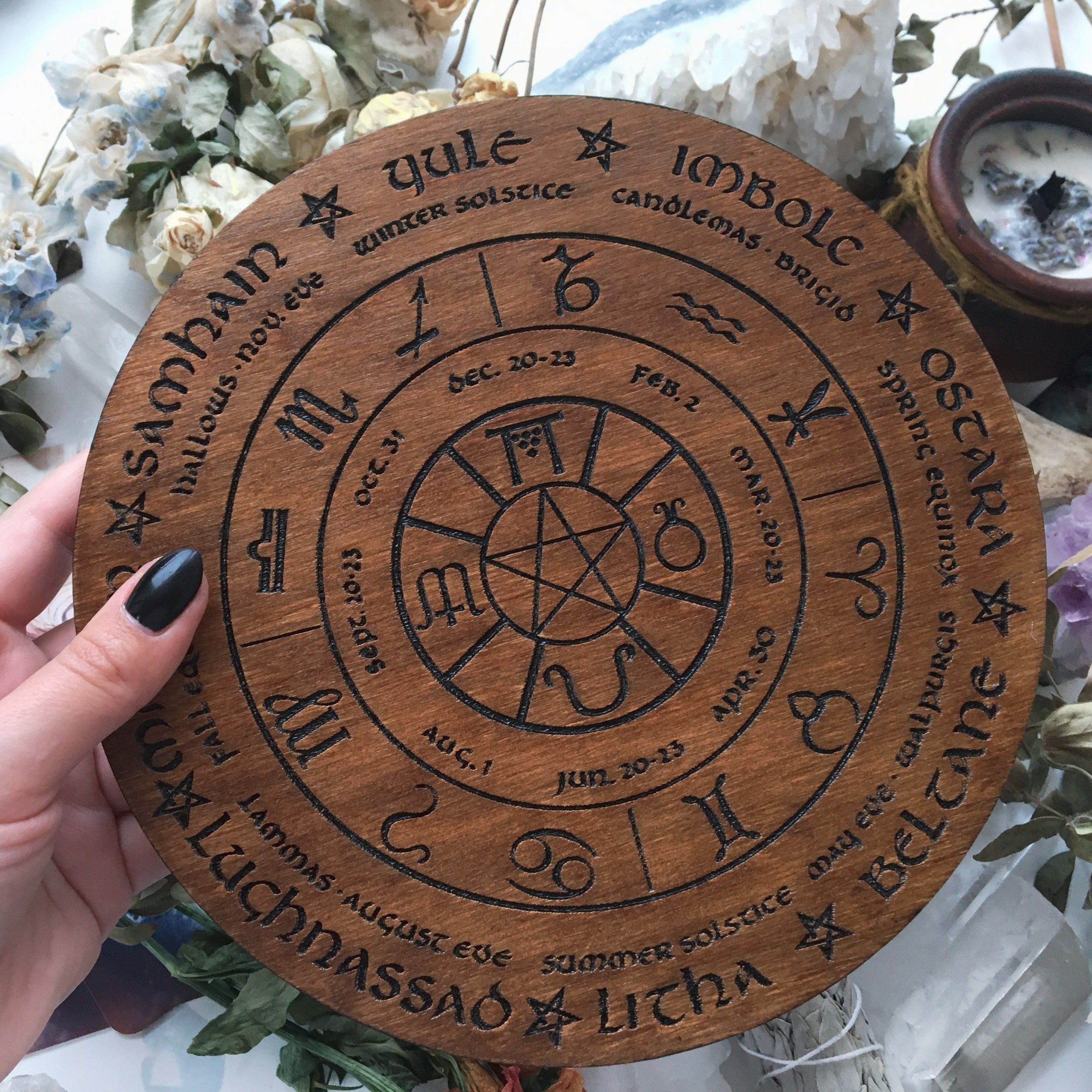 Wooden Wheel of the Year - calendar of pagan festivals and seasonal sabbaths: Yule, Imbolc, Ostara, Beltane, Litha, Lammas, Mabon, Samhain. 